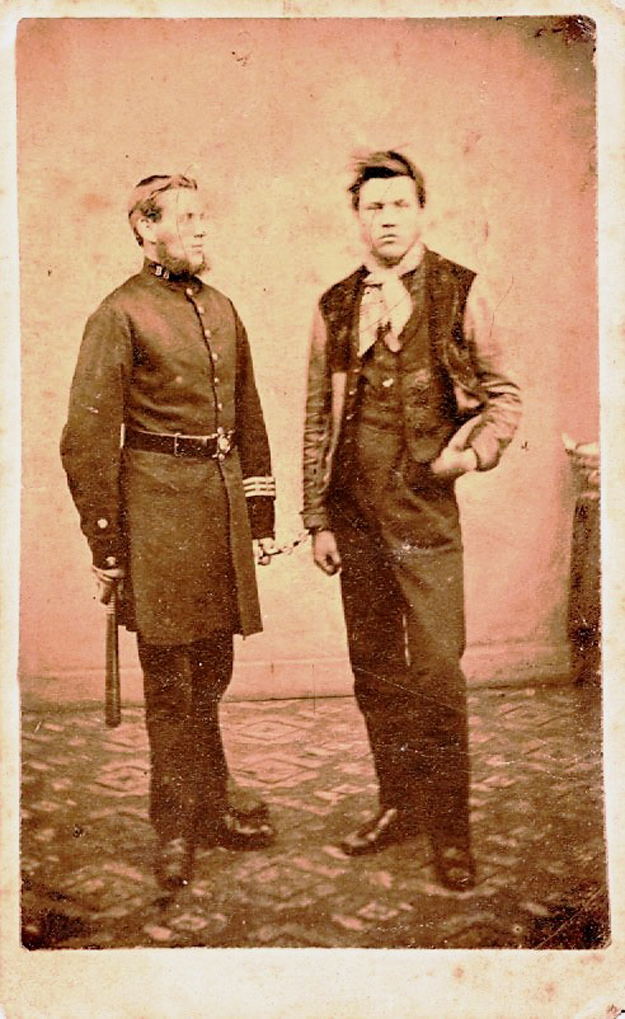 A young prisoner strikes a pose handcuffed to a Beverley Borough Police Officer, c.1860s